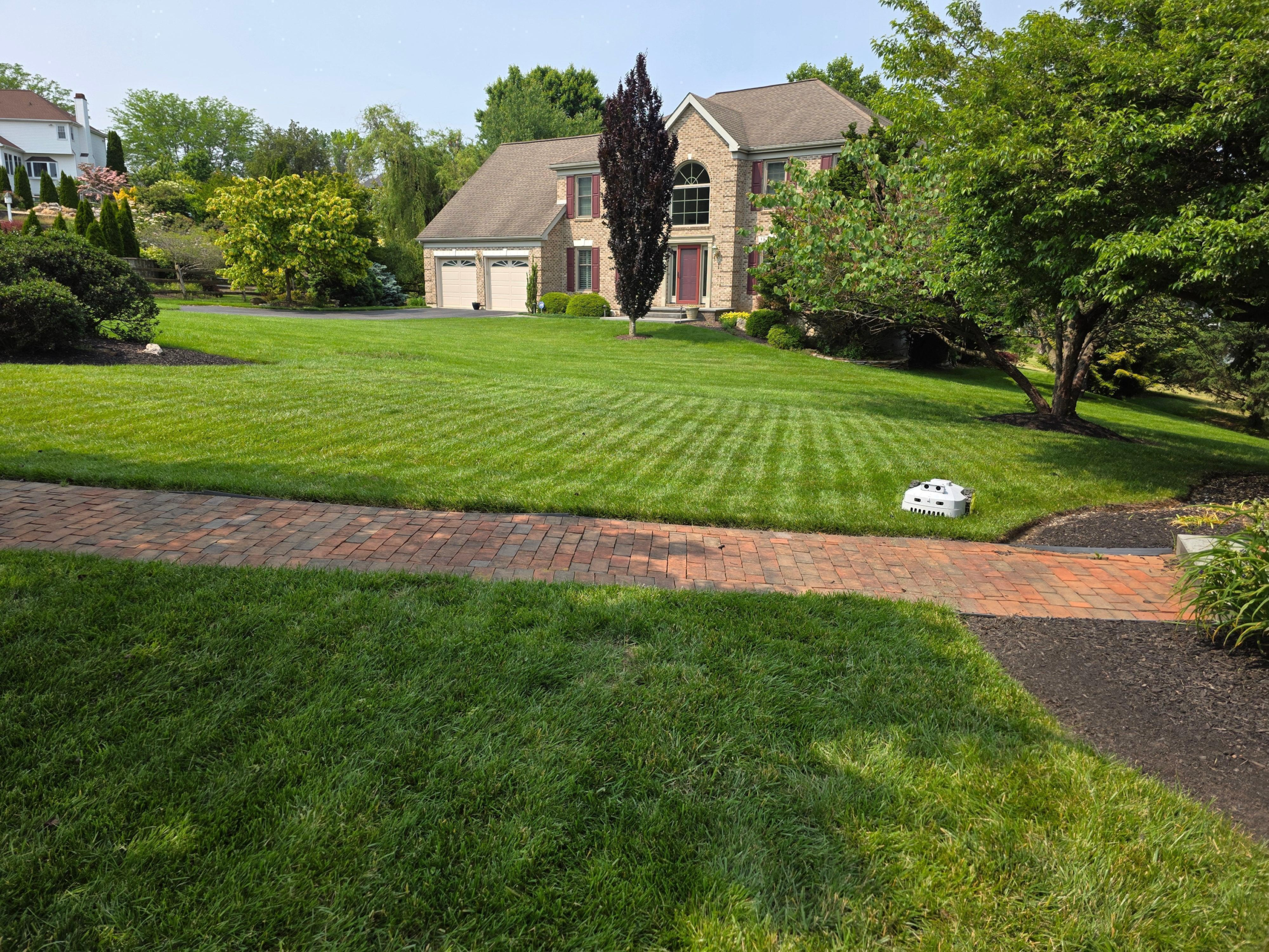 BESTMOW Titan-100 mowing a landscaped yard